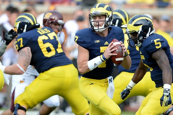 Kyle Kalis (67), Shane Morris (7), and Justice Hayes (5)