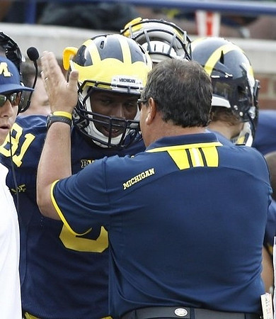 Csont'e York (81) and Brady Hoke
