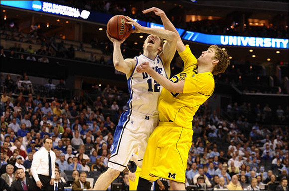Evan Smotrycz (23) and Mike Krzyzewski