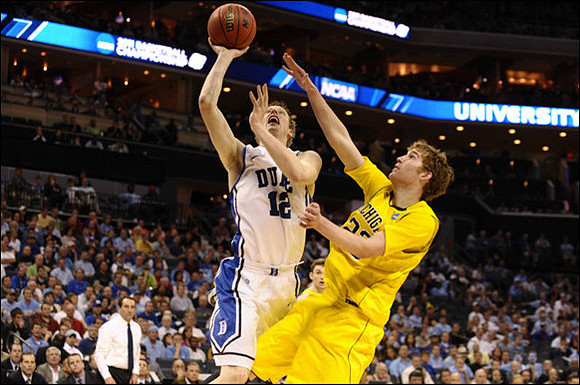 Evan Smotrycz (23) and Mike Krzyzewski