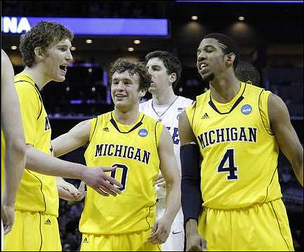 Evan Smotrycz (23), Zack Novak (0), and Darius Morris (4)