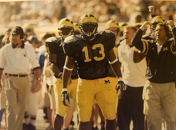 Lloyd Carr, Obi Oluigbo (81), Larry Stevens (13), and Brady Hoke