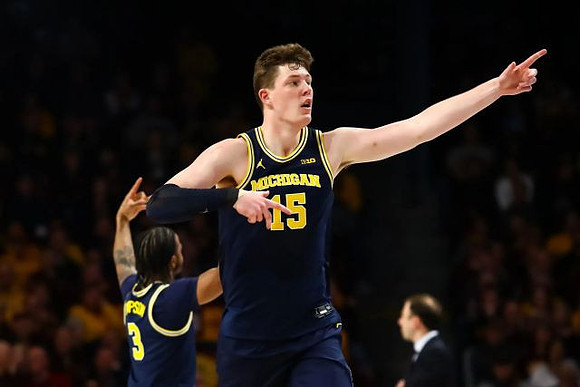 Zavier Simpson (3) and Jon Teske (15)