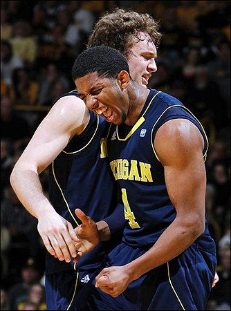 Zack Novak (0) and Darius Morris (4)