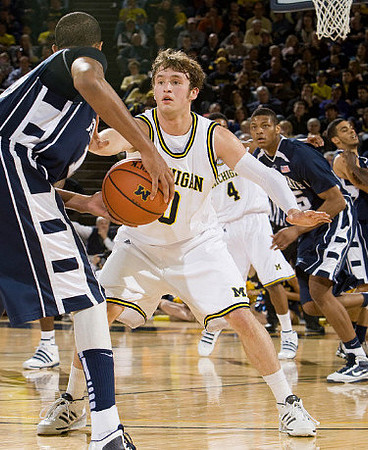 Zack Novak (0) and Darius Morris (4)