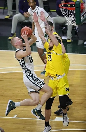 Brandon Johns Jr. (23) and Hunter Dickinson (1)