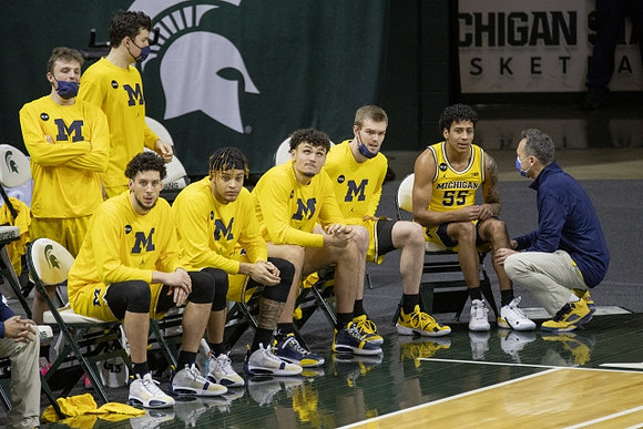 Eli Brooks (55) and Michigan Team