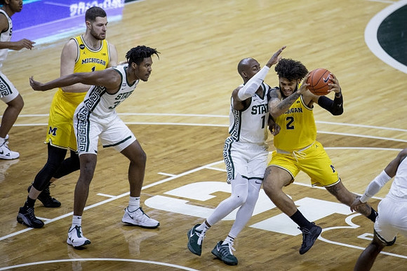Hunter Dickinson (1) and Isaiah Livers (2)