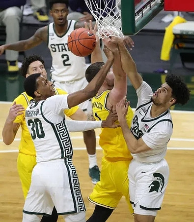 Brandon Johns Jr. (23) and Hunter Dickinson (1)