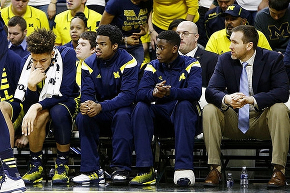 D.J. Wilson (5), Derrick Walton Jr. (10), and Caris LeVert (23)