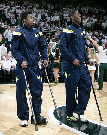 Derrick Walton Jr. (10) and Caris LeVert (23)