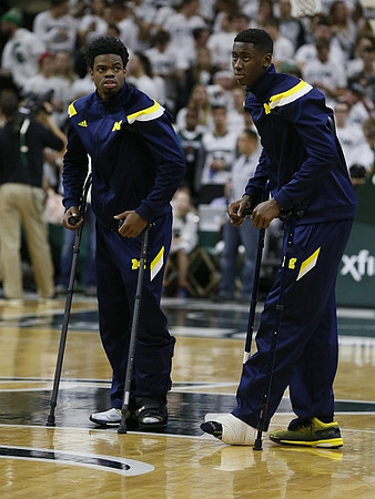 Derrick Walton Jr. (10) and Caris LeVert (23)