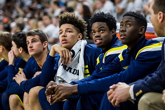 Austin Hatch (30), D.J. Wilson (5), Derrick Walton Jr. (10), and Caris LeVert (23)