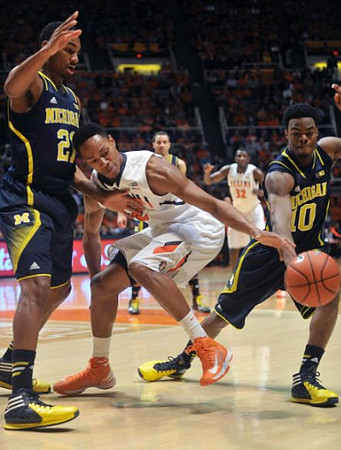 Zak Irvin (21) and Derrick Walton Jr. (10)