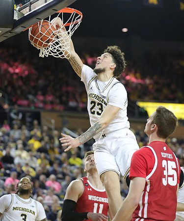 Brandon Johns Jr. (23) and Zavier Simpson (3)
