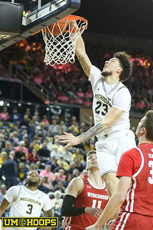 Zavier Simpson (3) and Brandon Johns Jr. (23)