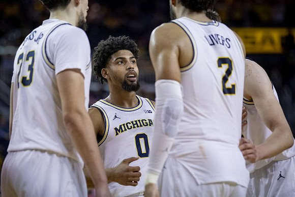 Brandon Johns Jr. (23), David DeJulius (0), and Isaiah Livers (2)