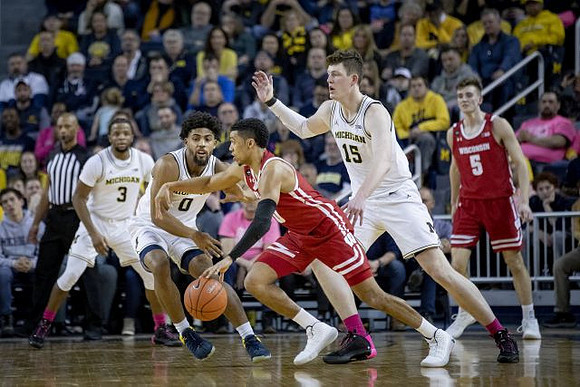 Zavier Simpson (3), David DeJulius (0), and Jon Teske (15)