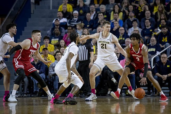Brandon Johns Jr. (23), Zavier Simpson (3), and Franz Wagner (21)