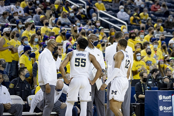 Eli Brooks (55), DeVante' Jones (12), and Juwan Howard