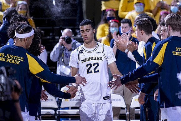 Caleb Houstan (22) and Michigan Team