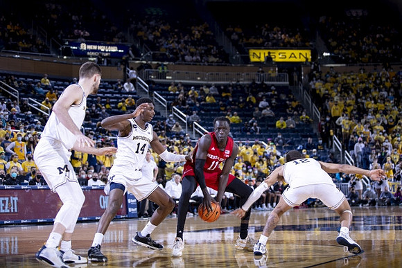 Hunter Dickinson (1), Moussa Diabate (14), and DeVante' Jones (12)