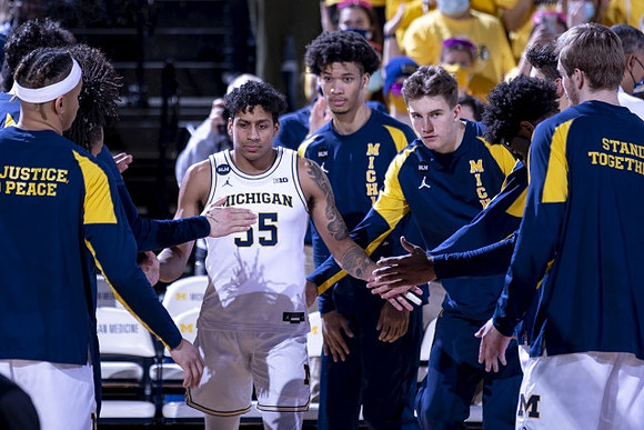 Eli Brooks (55) and Michigan Team