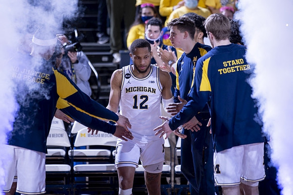 DeVante' Jones (12) and Michigan Team