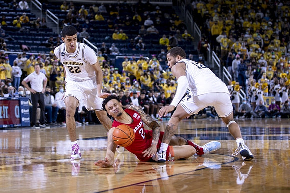 Caleb Houstan (22), DeVante' Jones (12), and Nebraska Head Coach Fred Hoiberg