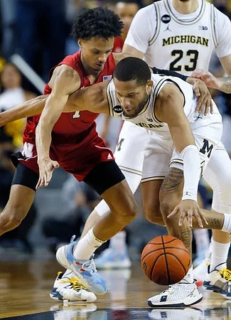 DeVante' Jones (12) and Brandon Johns Jr. (23)