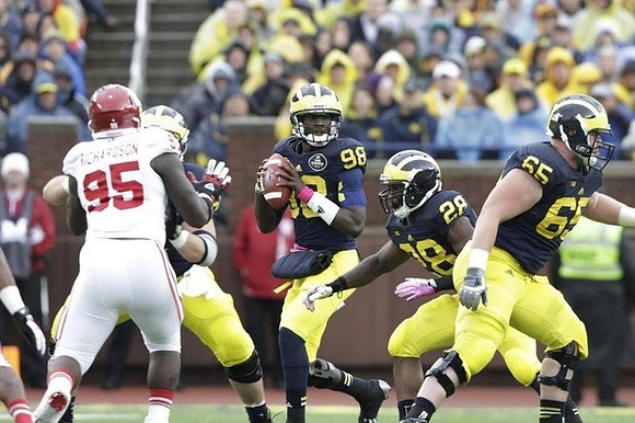 Devin Gardner (98), Fitzgerald Toussaint (28), and Kyle Bosch (65)