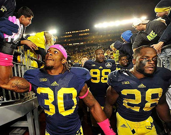 Thomas Gordon (30), Devin Gardner (98), and Fitzgerald Toussaint (28)