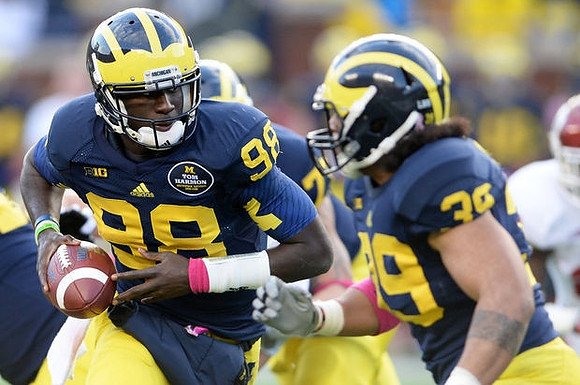 Devin Gardner (98) and Sione Houma (39)