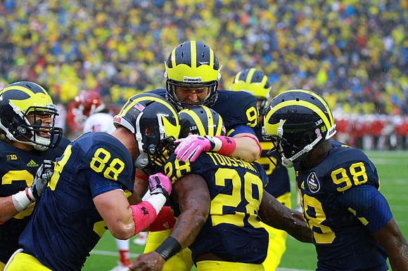 Sione Houma (39), Jake Butt (88), Jordan Paskorz (94), Fitzgerald Toussaint (28), and Devin Gardner (98)