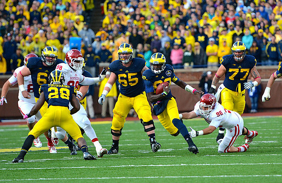 Graham Glasgow (61), Fitzgerald Toussaint (28), Kyle Bosch (65), Devin Gardner (98), and Taylor Lewan (77)