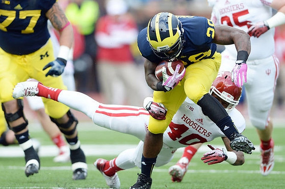 Taylor Lewan (77) and Fitzgerald Toussaint (28)
