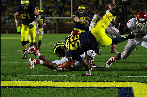 Graham Glasgow (61), Fitzgerald Toussaint (28), Devin Gardner (98), and Kyle Bosch (65)