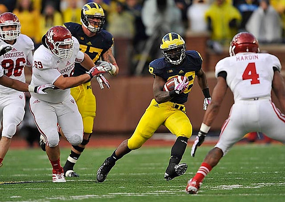 Taylor Lewan (77) and Fitzgerald Toussaint (28)