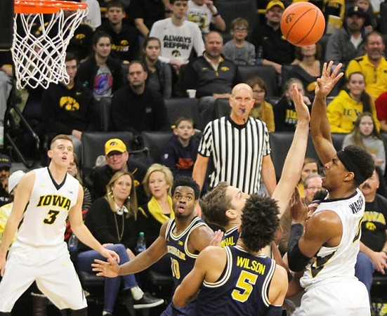 Derrick Walton Jr. (10), Mark Donnal (34), and D.J. Wilson (5)