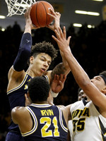 D.J. Wilson (5) and Zak Irvin (21)