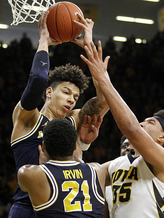 D.J. Wilson (5) and Zak Irvin (21)