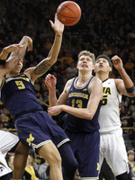 D.J. Wilson (5) and Moritz Wagner (13)