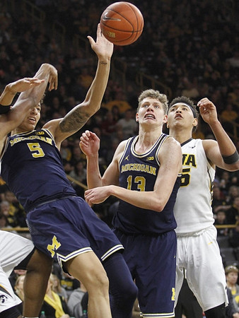 D.J. Wilson (5) and Moritz Wagner (13)
