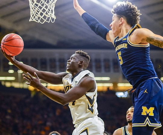 D.J. Wilson (5) and Zak Irvin (21)