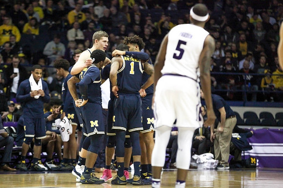 Moritz Wagner (13), Zavier Simpson (3), Charles Matthews (1), and Isaiah Livers (4)