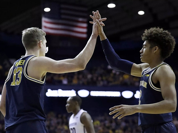 Moritz Wagner (13) and Jordan Poole (2)