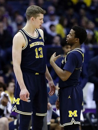 Moritz Wagner (13) and Zavier Simpson (3)