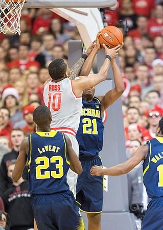 Caris LeVert (23), Zak Irvin (21), and Derrick Walton Jr. (10)