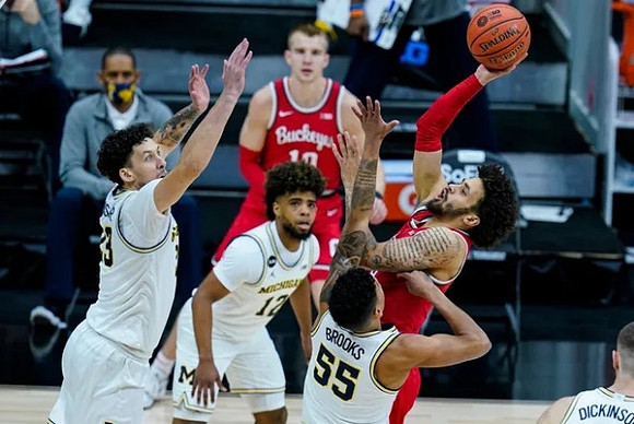 Brandon Johns Jr. (23), Mike Smith (12), and Eli Brooks (55)