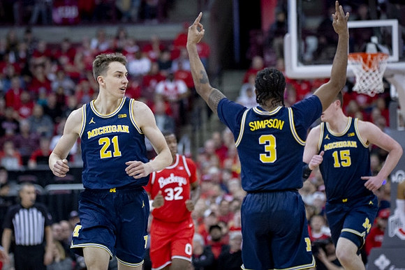 Franz Wagner (21), Zavier Simpson (3), and Jon Teske (15)